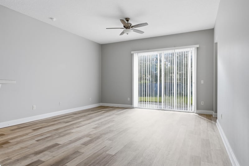 Living room with vaulted ceiling and sliding glass door at 14187 Big Spring St, Jacksonville, FL 32258