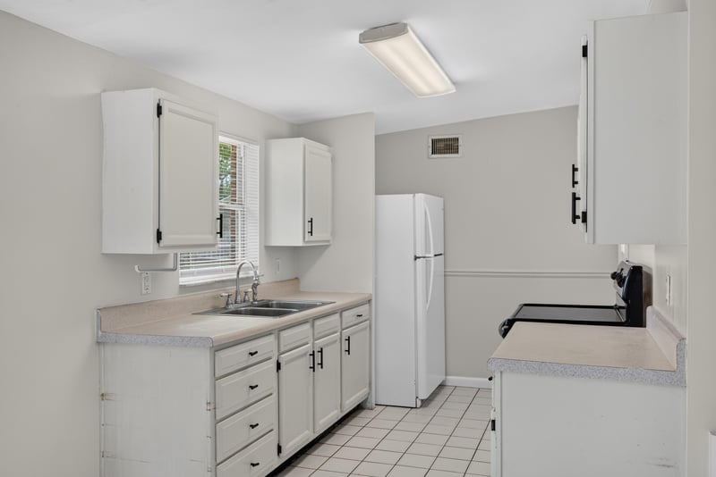 Kitchen with refrigerator and tile counters at 87 Saratoga Cir S, Atlantic Beach, FL