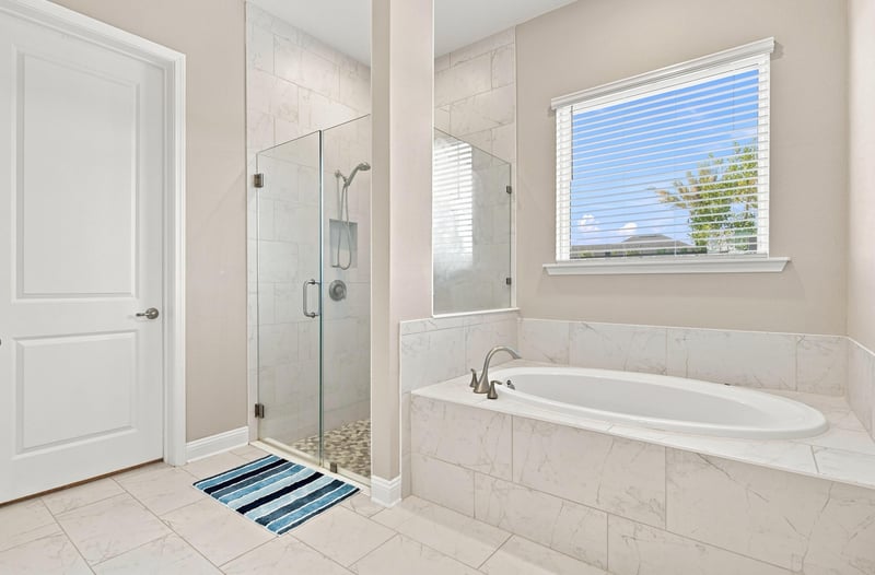 Primary bathroom with glass shower and soaking tub at 27 Holly Rdg Wy, St. Augustine, FL