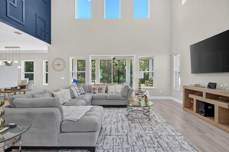 Living room with sectional and large windows at 22 Azura Point