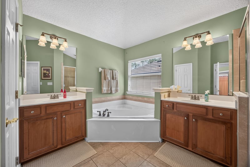Primary bathroom with dual vanities and a garden tub at 3660 Middlebrook Dr, Orange Park, FL 32065