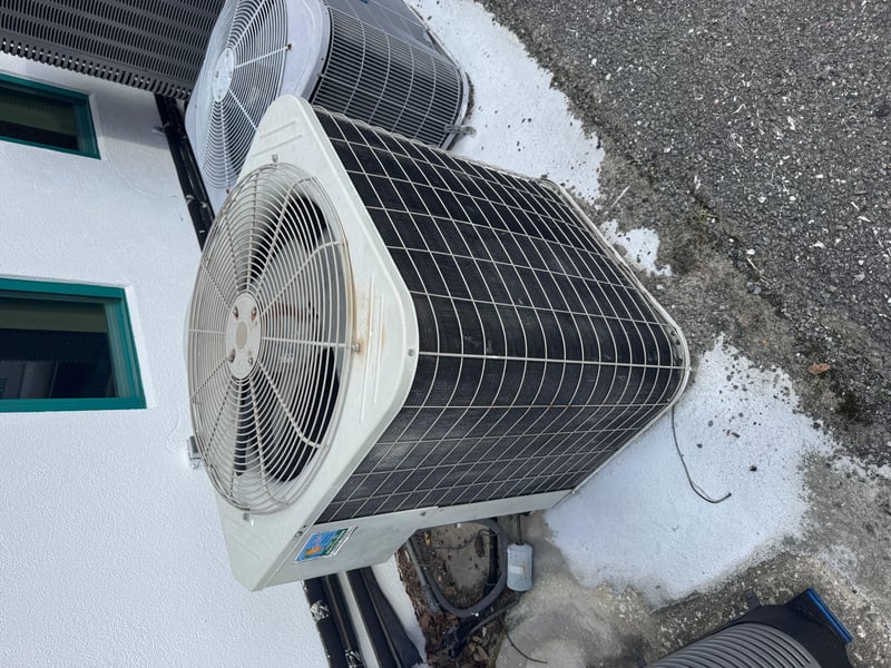 AC condenser unit with white fan cover at 11700 New Kings Rd, Jacksonville, FL 32219