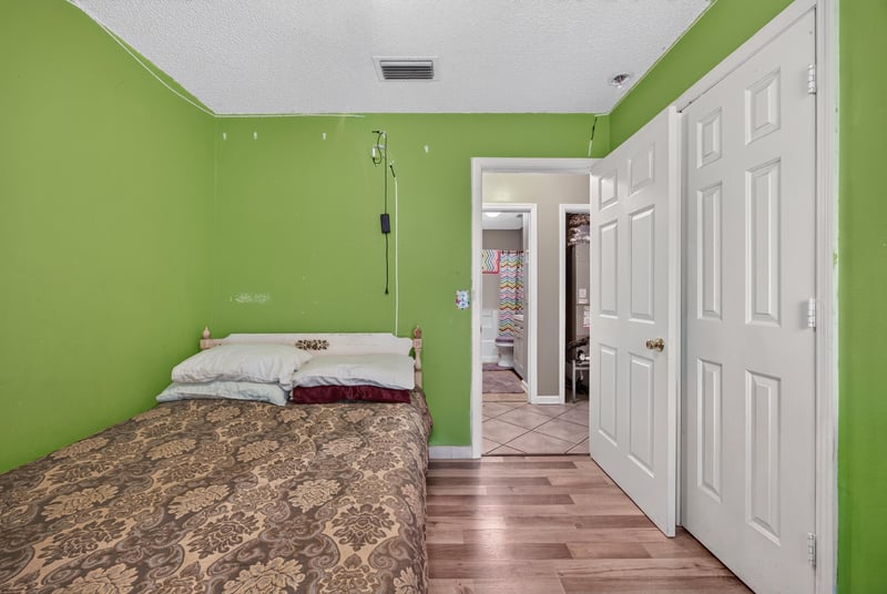 Bedroom with green walls and hallway view at 5375 Dodge Rd, Jacksonville, FL 32209