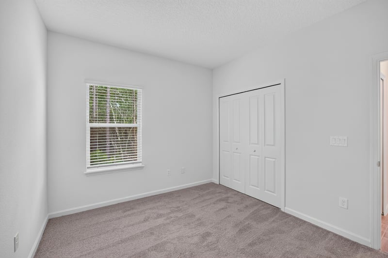 Bedroom with closet and window at 9905 Ansley Lake Dr, Jacksonville, FL