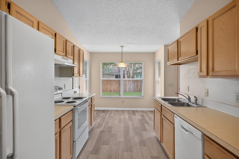 Kitchen with white appliances and window over sink at 6646 Shiloh Creek Dr