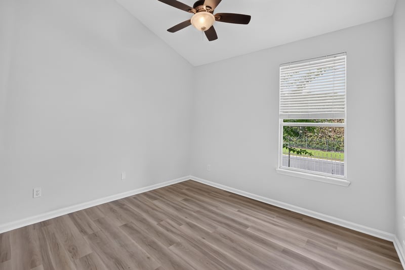 Bedroom with window and wood floor at 3101 E Banister Rd, St. Augustine, FL 32092