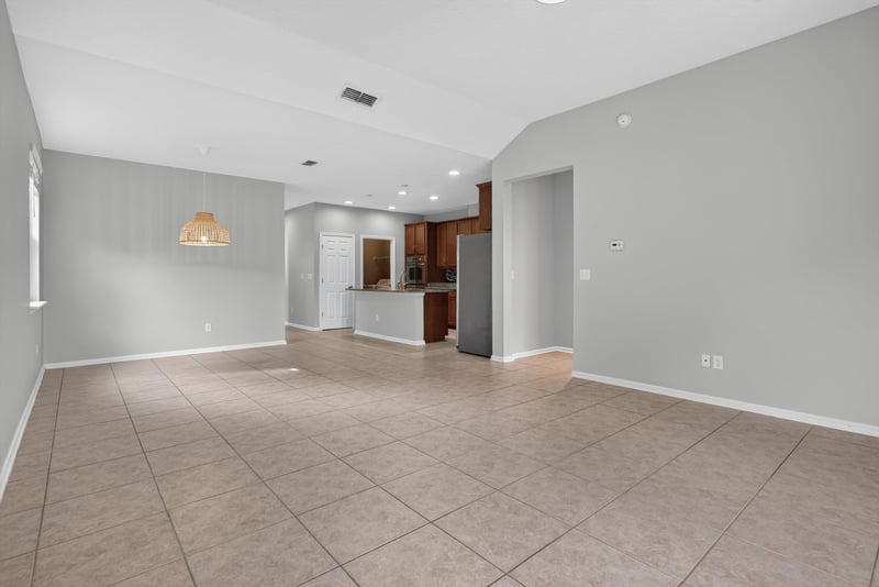 Open living and kitchen area with vaulted ceiling at 13685 Goodson Pl, Jacksonville, FL 32226