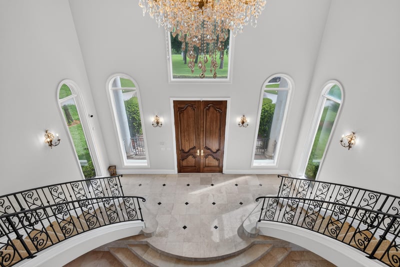 Upper foyer landing with wrought iron railings and arched windows at 344 Broward Rd, Jacksonville, FL