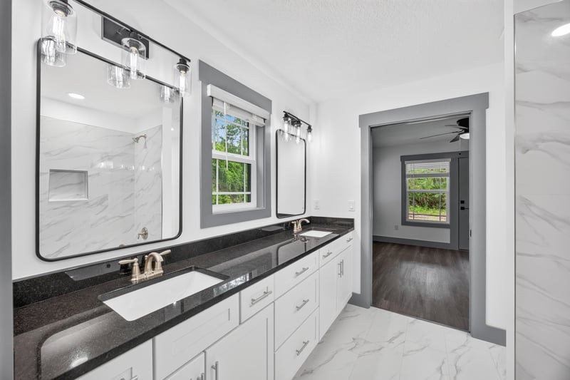 Bathroom with dual vanity and marble-look tile at 4800 Acacia St, Middleburg, FL 32068