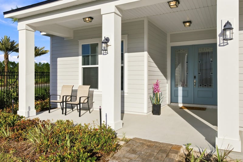 Covered front porch with columns and rocking chairs at 27 Holly Rdg Wy, St. Augustine, FL