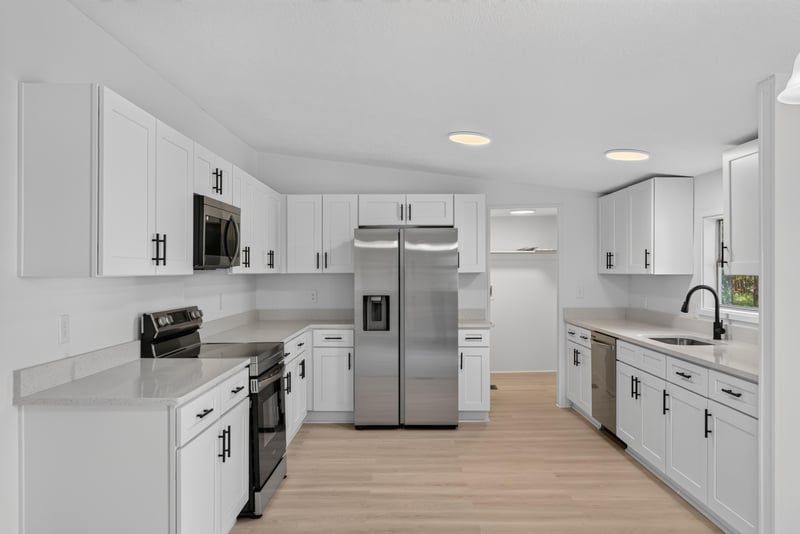 Kitchen with white cabinets and stainless appliances at 55520 Jewel-Thomas Rd, Callahan, FL 32011