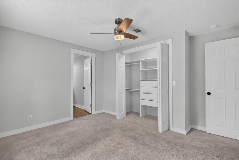 Bedroom walk-in closet with carpet flooring at 4890 McAllister Rd, Middleburg, FL 32068