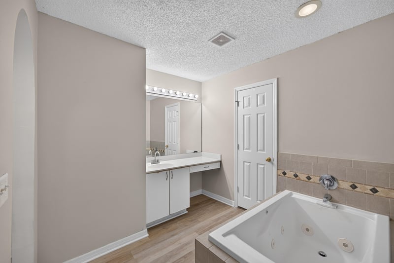 Primary bath with garden tub and dual vanity at 1845 Saga Ct, Middleburg, FL