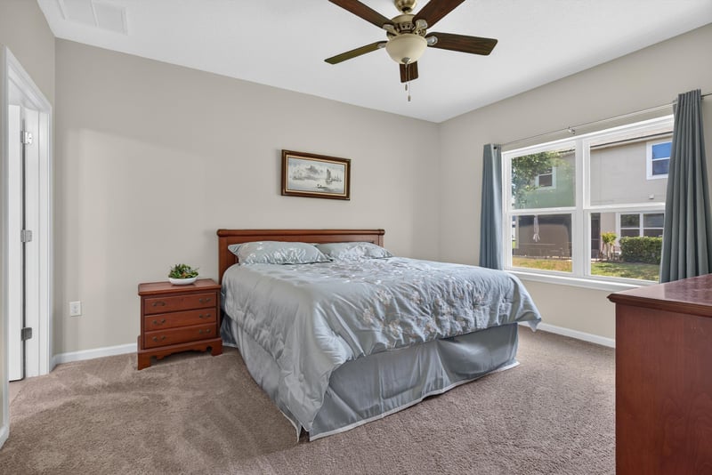 Primary bedroom with ceiling fan and window at 2378 Caney Oaks Dr, Jacksonville, FL
