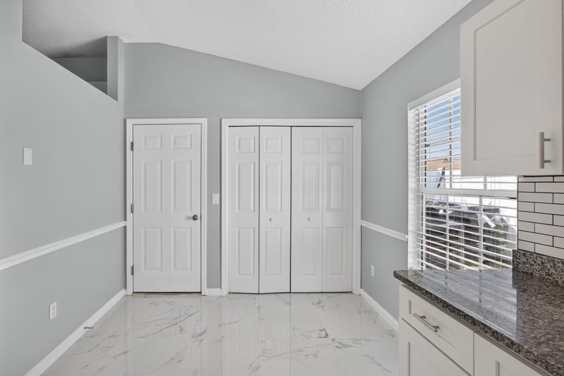Hallway with closet doors and tile flooring at 490 Hillside Dr, Orange Park, FL 32073