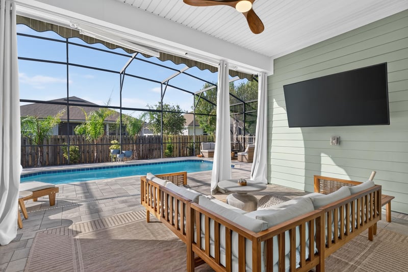 Covered lanai with seating overlooking the pool at 3328 Southern Oaks Dr, Green Cove Springs, FL 32043
