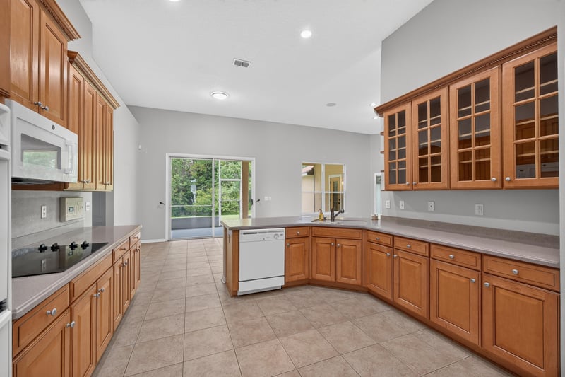 Kitchen with wood cabinets and glass-front uppers at 635 Wakeview Dr, Orange Park, FL 32065