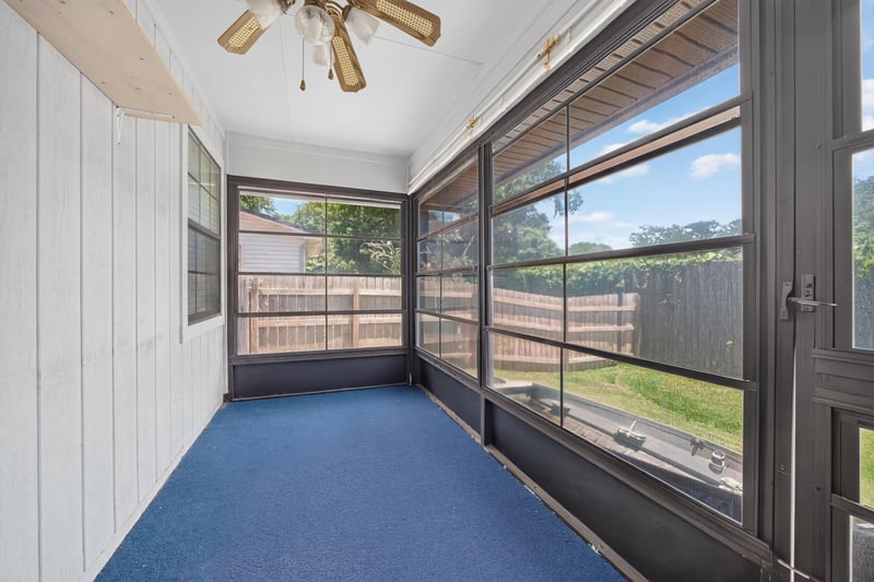 Empty screened porch with windows along the length at 2460 San Sago Ln, Jacksonville, FL