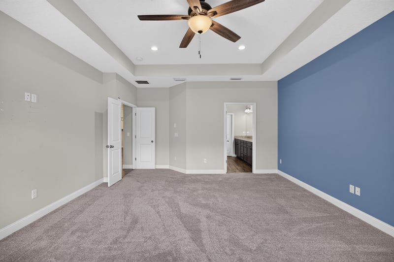 Empty carpeted room with tray ceiling at 53 Lumen Ct, St. Augustine, FL 32095