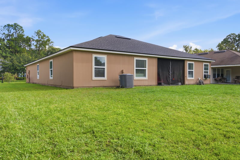 Rear exterior view of home and backyard at 7392 Timber Falls Ct