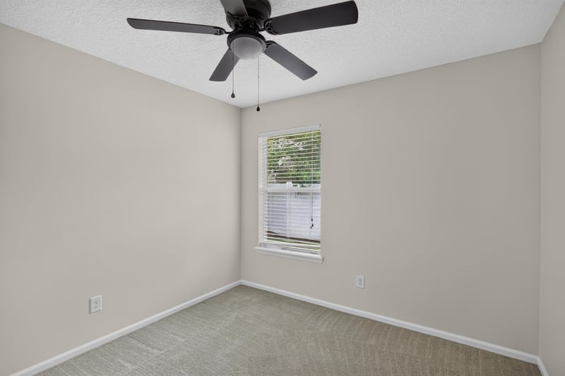 Bedroom with carpet and window at 605 N Covered Bridge Rd, Jacksonville, FL