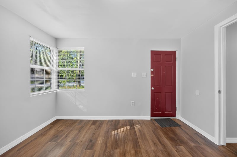 Living room with window and red door at 4951 Halls Dr