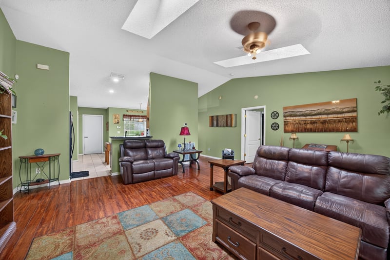 Family room with ceiling fan and skylights at 145 Dover Bluff Dr, Orange Park, FL