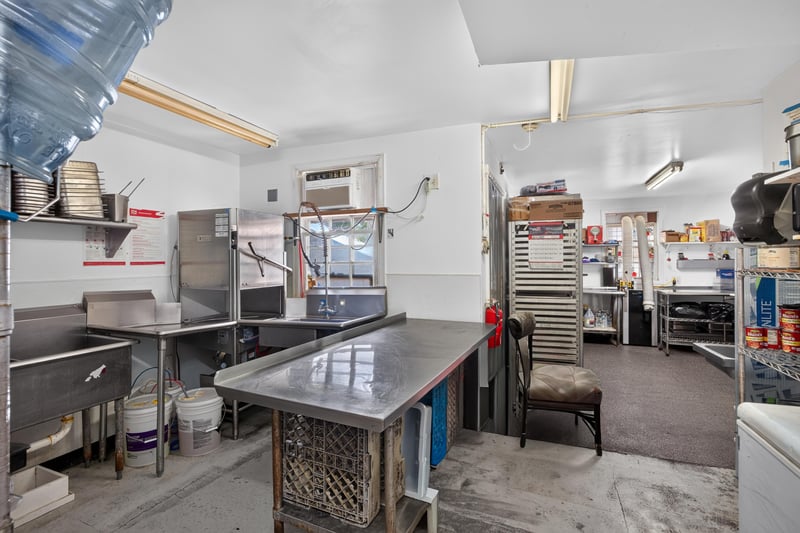 Kitchen storage with stainless steel shelving at 115 Cordova St, St. Augustine, FL