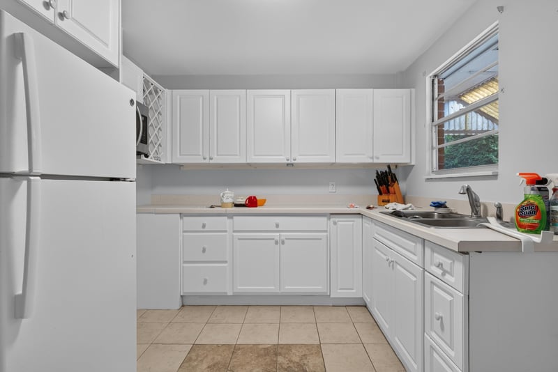 Second kitchen with white cabinets and window at 5745 110th St, Jacksonville, FL 32244