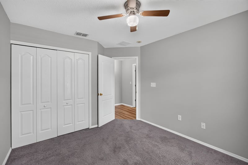 Hallway with closet doors and carpet at 7545 Lirope St, Jacksonville, FL 32244