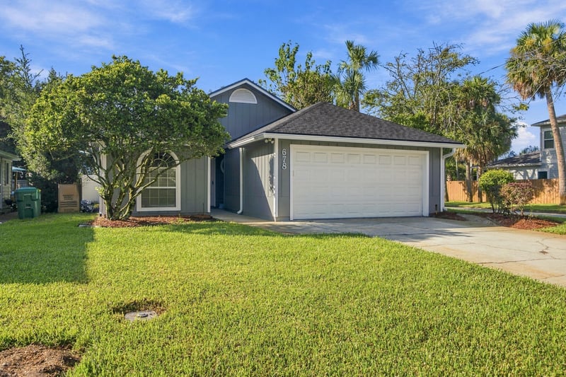 Front exterior view of driveway and gray siding at 678 5th Ave N, Jacksonville Beach, FL 32250