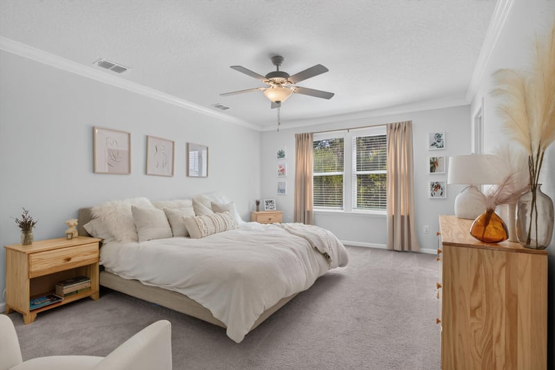 Primary bedroom with bed and dresser at 1186 Beach Dune Dr, Jacksonville, FL 32233