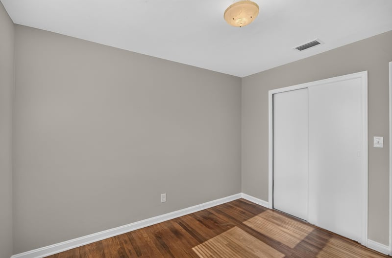 Room with closet doors and hardwood floors at 6338 Mercer Cir W, Jacksonville, FL