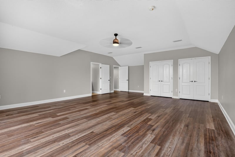 Large bedroom with double doors and wood floor at 4109 Eagle Landing Pkwy, Orange Park, FL 32065