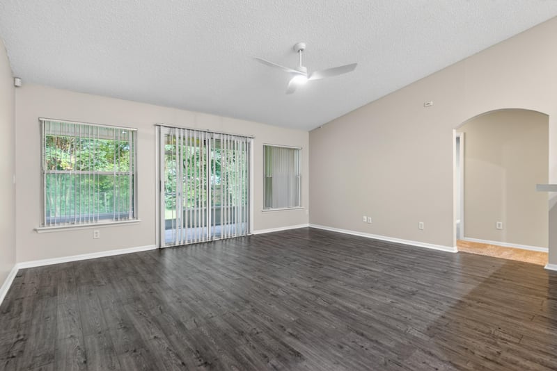 Living room with wood flooring and sliding glass doors at 1648 Glen Laurel Dr, Middleburg, FL 32068