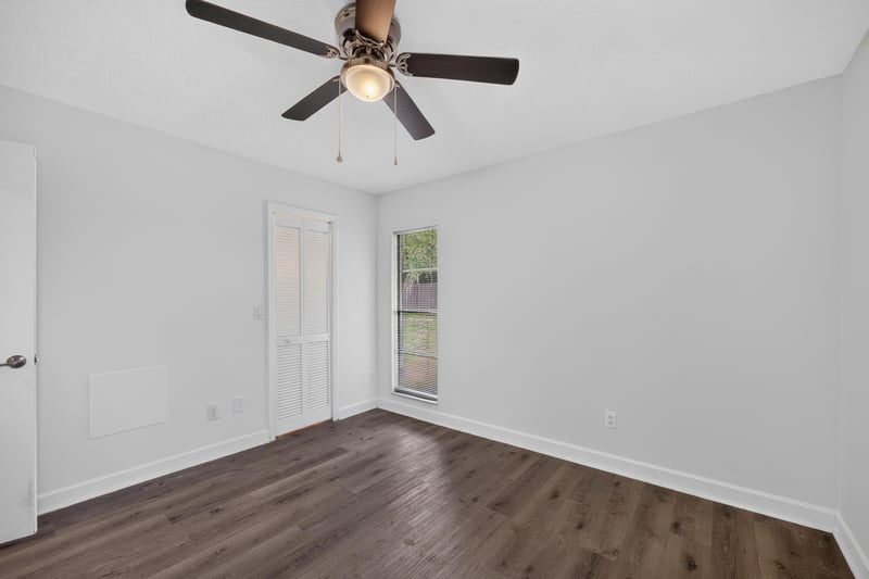 Bedroom with wood floor and closet door at 551 Deltona Blvd, St. Augustine, FL 32086