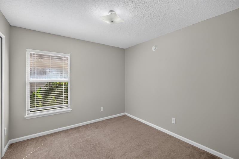 Carpeted bedroom with window at 14147 Fish Eagle Dr E, Jacksonville, FL 32226