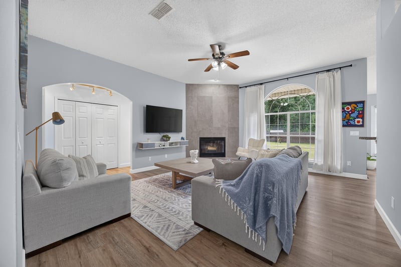 Living room with fireplace and sofa seating at 8921 Needlepoint Pl, Jacksonville, FL 32244