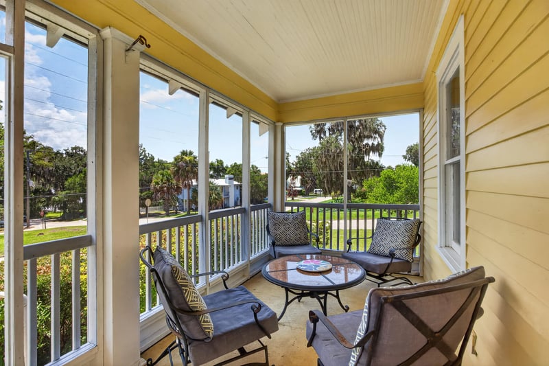 Porch seating area with small tables at 101 N Lake St, Crescent City, FL