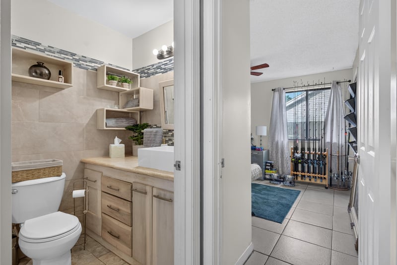 Bathroom with toilet and open shelving at 13020 Medford Ln, Jacksonville, FL 32225