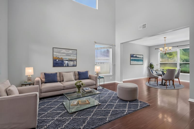 Entry and living room with two-story ceiling, staged furniture at 470 Sparrow Branch Cir, Jacksonville, FL 32259