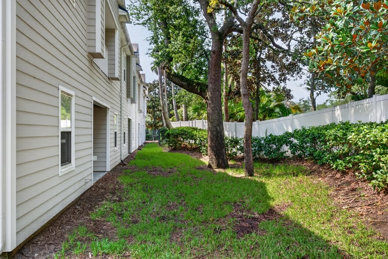 Side exterior walkway with trees at 8196 Cabin Lake Cir, Jacksonville, FL 32256