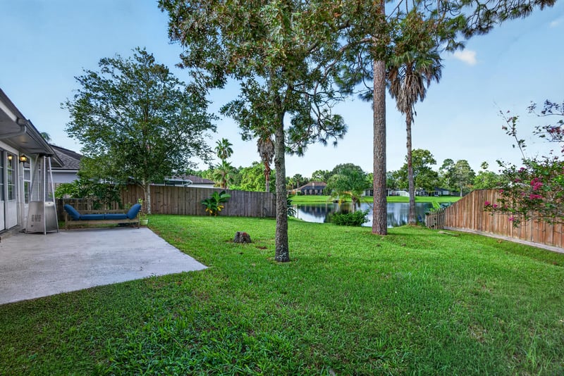Backyard patio with hammock and lawn at 4556 Shaky Leaf Ln N, Jacksonville, FL 32224