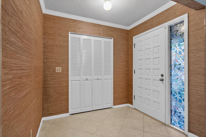 Foyer with closet doors and tile floor at 3515 Cormorant Branch Ct, Jacksonville, FL