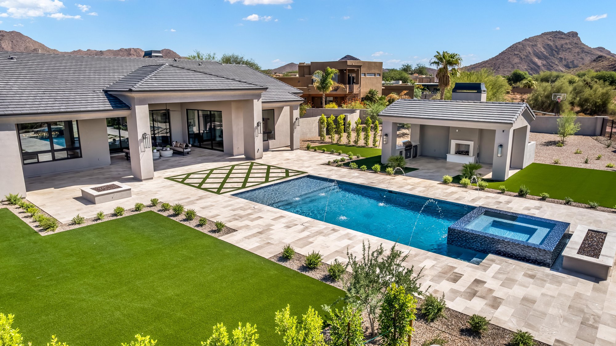 Aerial of a long pool and spa between the house and a guest casita