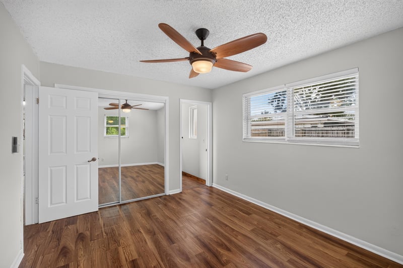 Bedroom with mirrored closet doors and windows at 4039 Habana Ave, Jacksonville, FL
