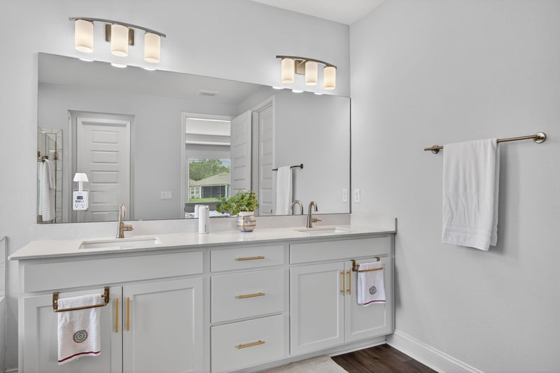 Primary bathroom vanity with large mirror at 85491 Fall River Pkwy, Fernandina Beach, FL 32034