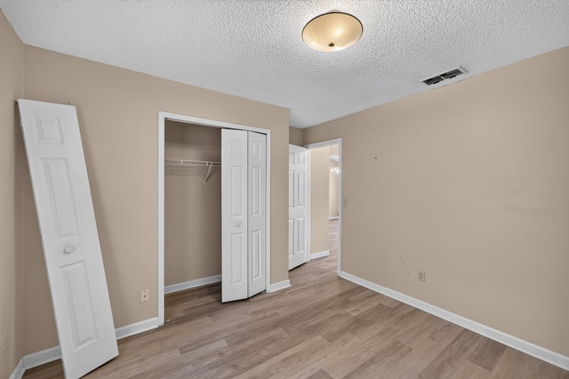 Bedroom with closet and wood-look floors at 6646 Shiloh Creek Dr