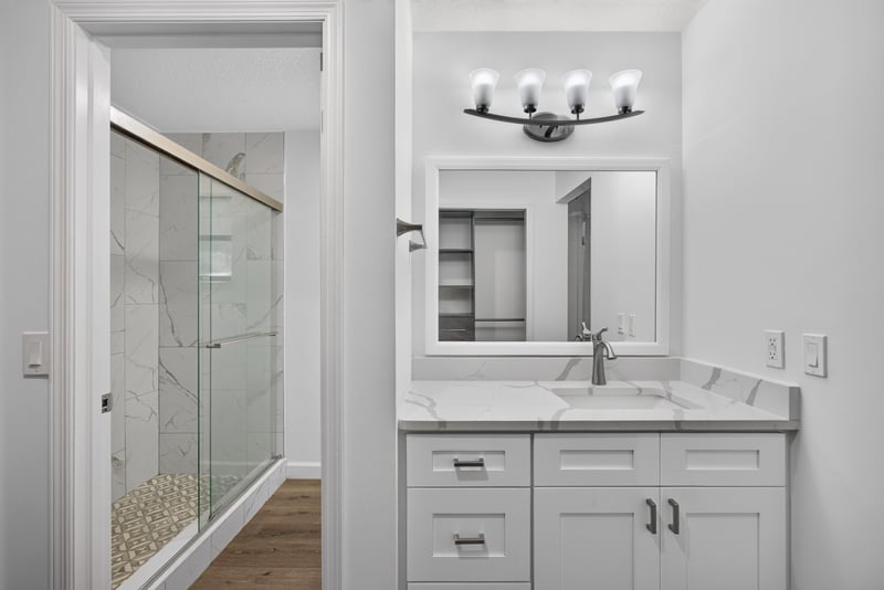Bathroom with double vanity and glass shower at 551 Deltona Blvd, St. Augustine, FL 32086