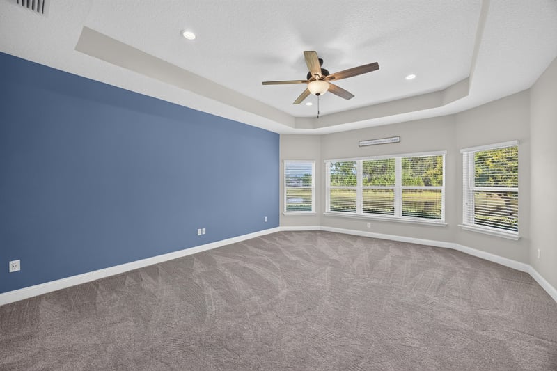 Bedroom with blue accent wall, carpet and windows at 53 Lumen Ct, St. Augustine, FL 32095